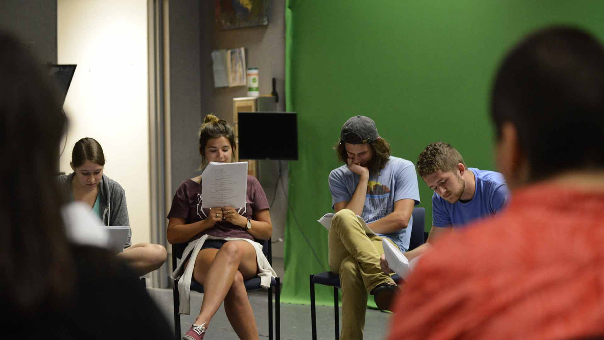 Students reading scripts.